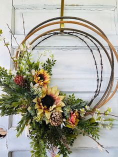 a wreath is hanging on the door with flowers