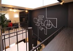 an office with black walls and white lettering on the wall