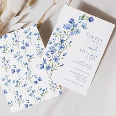 two wedding cards with blue flowers on them