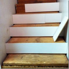 the stairs are painted white and have wooden treads