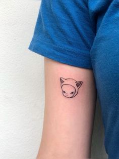 a small fox head tattoo on the left inner forearm and arm, with black ink