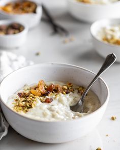 a white bowl filled with oatmeal and nuts