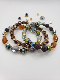 Diffuser Bracelet is comprised of dark brown lava beads, gold colored metal spacers with bronze and metallic glass beads beaded on stretch string.  To see more diffuser bracelets go to my website at https://www.ferdysjoy.com  Measure your wrist where you will be wearing your bracelet.  Flexible tape measure work great but a string wrapped around your wrist will work, too.  Measure the circumference and then lay the string down on a ruler or tape measure to get your wrist size.  Adding desired co Essential Oil Bracelet, Lava Beads, Diffuser Bracelets, Lava Bead, Tape Measure, Bracelet Stack, Ruler, Essential Oil, Snug Fit