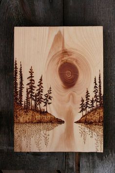 a painting on wood with trees and water in the center, depicting an eye opening