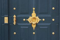 a blue door with gold decorations on it