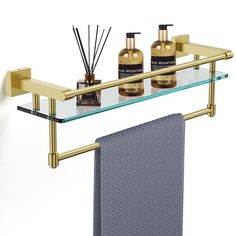 a shelf that has some bottles and soaps on it next to a towel rack