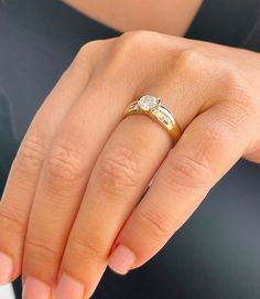 a woman's hand with two rings on it