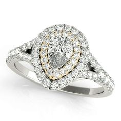 a pear shaped diamond ring with two tone gold accents