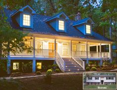 a large white house with blue roof and stairs leading up to the front door at night