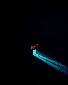 an exit sign is lit up in the dark