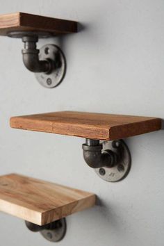 two wooden shelves with metal brackets on them