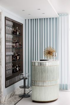 an image of a bar in the middle of a room with blue and white curtains