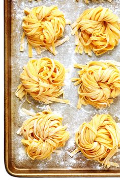 four uncooked pastas on a baking sheet ready to go into the oven