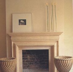 a living room with a fire place and two vases