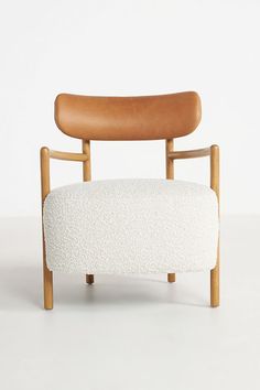 a white chair with a wooden armrest and seat cushion on the back, in front of a white background