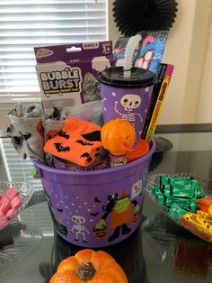 a halloween bucket filled with candy and decorations