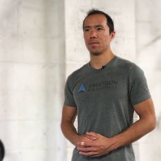 a man standing in front of a white wall