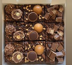 a box filled with lots of different types of chocolates on top of each other