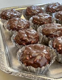 chocolate muffins sitting on top of a metal tray