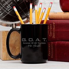 a black mug filled with pencils next to books