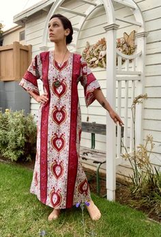 Queen of Hearts Kaftan, by i.Tink Studios This is a one-of-a-kind, Kaftan style dress I constructed from a vintage, polished cotton by Everfast Fabrics, Inc., using the vintage 1960's red dress pictured as a prototype. The fabric has a nice weight to it and a gorgeous sheen. An easy to wear piece that speaks elegance and mystery.  Easy, slip-over-the-head styling, flared 3/4 length sleeves, flexible sizing depending on desired fit.  GARMENT MEASUREMENTS: bust 40"  hips 42"  total length 52" For reference, model is 5'6", 34" bust Message me if you have any questions and I'll get right back to you! Vintage Long Printed Dresses, Fitted Bohemian Kaftan With Kimono Sleeves, Fitted Cotton Bohemian Kaftan, Bohemian Fitted Short Sleeve Kaftan, Fitted Bohemian Short Sleeve Kaftan, Vintage Summer Dress With Kimono Sleeves, Retro Cotton Dresses For Festival, Vintage Cotton Tunic Dress, Red Vintage Cotton Maxi Dress