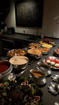 a buffet table filled with lots of different foods and dipping sauces on it's sides