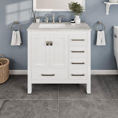 a bathroom with blue walls and white fixtures, including a mirror above the vanity sink