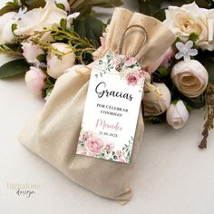 a bag that has some flowers in it and a tag on the front of it