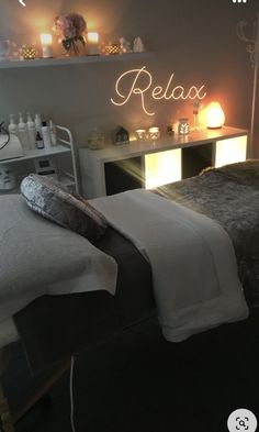 a couple of beds sitting next to each other in a room with candles on the wall