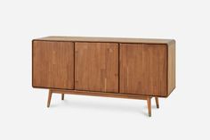 the sideboard is made from wood and has three doors, two drawers and one drawer