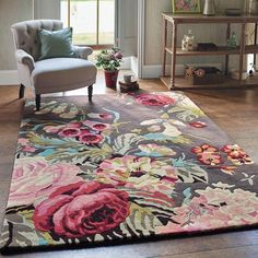 a living room with a chair and rug on the floor