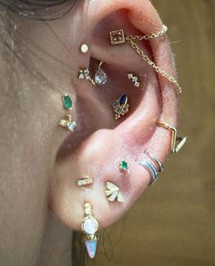 an ear with several different types of piercings on it