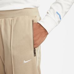 Style No. DQ4996-247 Color: Khaki/White Nike obsessed over the fabrics, details and craft to transform them into a streetwear staple you can wear anywhere. Soft blended poly-knit fabric feels smooth against your skin for daily comfort. Standard fit for a relaxed, easy feel. Zippered hand pockets. Elastic waistband with drawcord. 62% Cotton/38% Polyester. Nike Sportswear Authentics Men's Track Pants. White Nike, Color Khaki, White Nikes, Nike Sportswear, Track Pants, Your Skin, Knit Fabric, Knitted Fabric, Track