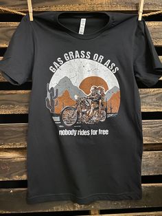 a black t - shirt with an image of a motorcyclist on it