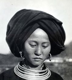 an old photo of a woman wearing a turban and necklaces on her head