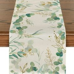 a table runner with green leaves on it