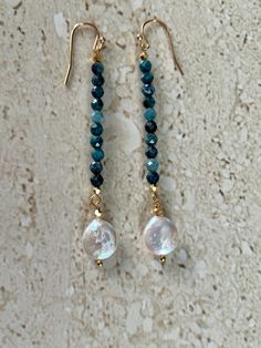 Neon Apatite earrings featuring 5MM faceted neon apatite stones accented with a coin pearl and gold filled ear wires.  Earrings measure 2 1/2 inches.  Handmade GIFT BOXED Apatite Dangle Earrings With Natural Stones, Pearl Long Earrings, Ear Art, Long Pearl Earrings, Stacked Earrings, Pearl Dangle Earrings, Coin Pearls, Earrings Inspiration, Handcrafted Artisan Jewelry