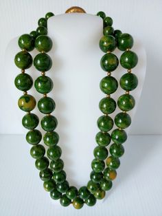 Original circa 1930's-1950's Vintage Green with Yellow Swirls Marbleized Bakelite Catalin Double Strand beads necklace ... Heavy about 227 Grams before packing.. The green with yellow swirl beads are expertly crafted and accented by a yellow gold tone metal ball/bead inbetween... Very pretty design necklace with the smaller beads at the end by the clasp, see picture .... Necklace is a unique addition to any jewelry collection.... Double strand round Bakelite Catalin beads and push lock closure... This vintage piece is an original and adds a touch of beauty and art to any look....Pictures are part of the description.... Before bidding, ask all the questions that are important to you and see the photos for all details and measurement.... Thank you. Vintage Bakelite Jewelry, 1930s Jewelry, Vintage Jewelry Antique, Bakelite Jewelry, Picture Necklace, Nouveau Jewelry, Antique Jewelry Necklace, Jewerly Making, Jewelry Antique