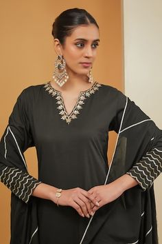 Black kurta with placement hand embroidery using zari work. Paired with a sharara and stripe pattern, hand embroidered dupatta. - Aza Fashions Black Palazzo Set With Gota Work, Elegant Black Salwar Kameez With Gota Work, Black Straight Kurta Set With Gota Work, Black Palazzo Set With Gota Work For Eid, Elegant Black Anarkali Set With Gota Work, Elegant Unstitched Blouse Palazzo Set For Eid, Elegant Black Sharara With Gota Work, Black Palazzo Set With Gota Work For Festive Season, Black Palazzo Set With Gota Work For Festive Occasions