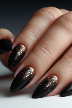 Glittery black nails are a perfect choice for a night out or special events. These designs offer sophistication and elegance, and match with any outfit. Discover the most stunning glittery black nail styles for inspiration!  #GlitteryBlackNails #BlackNailArt #NightElegance #NailTrends Black And Gold Xmas Nails, Christmas Nails Gold And Black, Black Tan Ombre Nails, Gold And Black Ombre Nails, Black And Gold Ombre Nails Glitter, Black Nails Gold Flakes, Black With Sparkle Nails, Black Christmas Nails Almond, Matte Black And Gold Nail Ideas