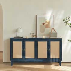 a blue cabinet with wicker doors in a white living room next to a potted plant