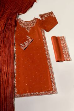 Meticulously crafted from a remarkably glamourous shade of burnt orange ( pure raw silk 60 gms )“ Minaree “ with its intricate zari details strikes the perfect balance between elegant and eye-catching, making this beautiful design a must have. The length of the long kameez is 46 inches.Agha Noor’s style tip - “ Style w Silk Kurta For Formal Festivals, Formal Silk Kurta For Festivals, Festive Orange Dupatta With Intricate Embroidery, Designer Orange Dupatta With Intricate Embroidery, Designer Wear Orange Dupatta With Intricate Embroidery, Elegant Dola Silk Salwar Kameez With Cutdana, Formal Silk Salwar Kameez With Cutdana, Elegant Raw Silk Kurta For Festivals, Traditional Formal Salwar Kameez In Tissue Silk