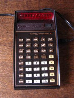 a calculator sitting on top of a wooden table