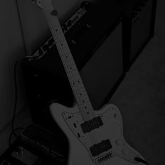 an electric guitar sitting next to a amp