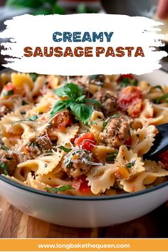 creamy sausage pasta in a white bowl on a wooden table with text overlay that reads, creamy sausage pasta