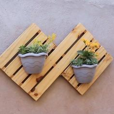 two wooden pallets with planters mounted to the side of each other on top of them