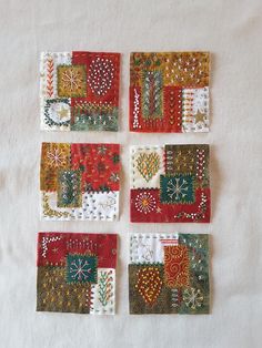 four square patchwork pieces on a white surface