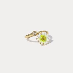 The Daisy Ring, with its open and adjustable design, feels like a delicate bloom resting upon your hand. Each petal is handcrafted in enamel, set upon 18K gold-plated brass, as though plucked straight from a morning garden. A sparkling cubic zirconia sits at the heart of the daisy, catching the light like morning dew. The adjustable band ensures a perfect fit, allowing this graceful flower to adorn any finger, bringing with it a timeless charm and a reminder of nature’s simple beauty. DETAILS Plating: 18K Gold Materials:   18K Gold on Brass, Enamel, Cubic Zirconia Size: Adjustable, 0.47"*0.67"(12mm*17mm) Weight: 3.5 g Dainty Flower-shaped Enamel Jewelry, Yellow Gold Enamel Flower Jewelry, Gold Enamel Flower Ring For Anniversary, Gold Flower-shaped Enamel Ring, Gold Enamel Flower Ring, Flower Shaped Enamel Wedding Rings, Adjustable Flower Enamel Ring As Gift, Flower Shaped Enamel Ring As A Gift, Flower Shaped Enamel Ring For Gift