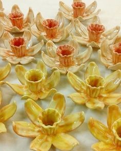 a group of ceramic flowers sitting on top of a table