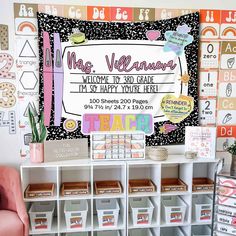 a bulletin board is displayed in front of a pink chair and white bookcases